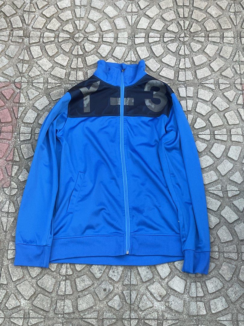 Y-3 Blue Track Jacket with Black Logo (Category: Coats, Jackets and Outerwear) located in Mabalacat. Submitted by epicforest_78284 (Listing ID 1462399921, Image 1). Description: - Blue Y-3 track jacket - Black Y-3 logo across the chest - Full zip closure - Stand-up collar - Two side pockets - Ribbed cuffs and hem - Ideal for casual wear or athletic activities.