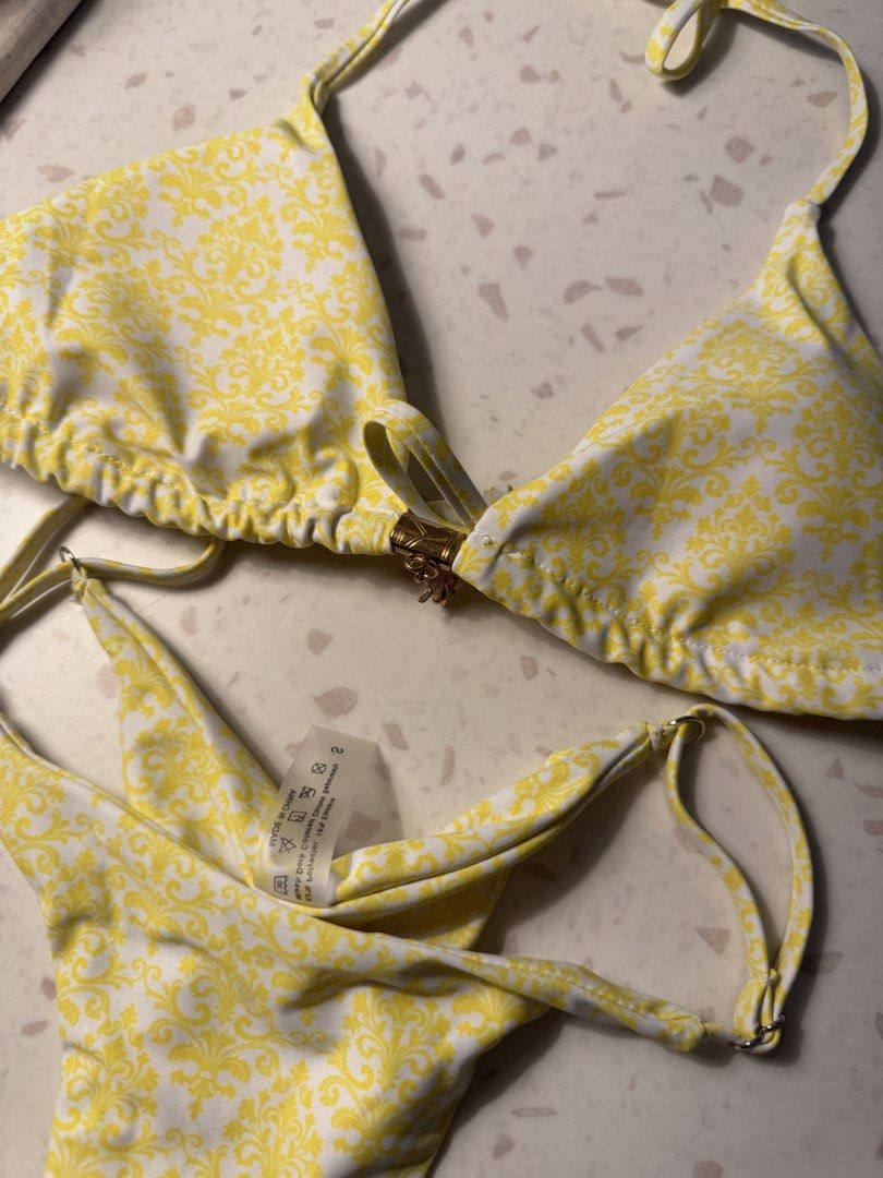 Yellow Baroque Print Bikini Set with Starfish Charm (Category: Bikinis & Swimsuits) located in Las Pinas. Submitted by patringcia_14 (Listing ID 1462322773, Image 2). Description: - Cute yellow bikini with a stylish baroque-inspired print. - Features adjustable tie straps for a perfect fit. - Adorned with a delicate gold-tone starfish charm on the front. - Bikini bottoms have trendy ruched detailing on the sides. - Ideal for beach days and pool p