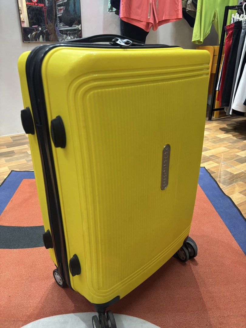 Yellow Hard Shell Spinner Luggage (Category: Luggage) located in Alicia. Submitted by thriftbagph (Listing ID 1462417624, Image 1). Description: - Bright yellow hard shell suitcase - Four spinner wheels for easy gliding - Retractable handle for comfortable transport - Secure zipper closure - Interior features straps and a zippered compartment - Shows minor scuffs and marks from regular travel use - Ideal for your next adventure!.