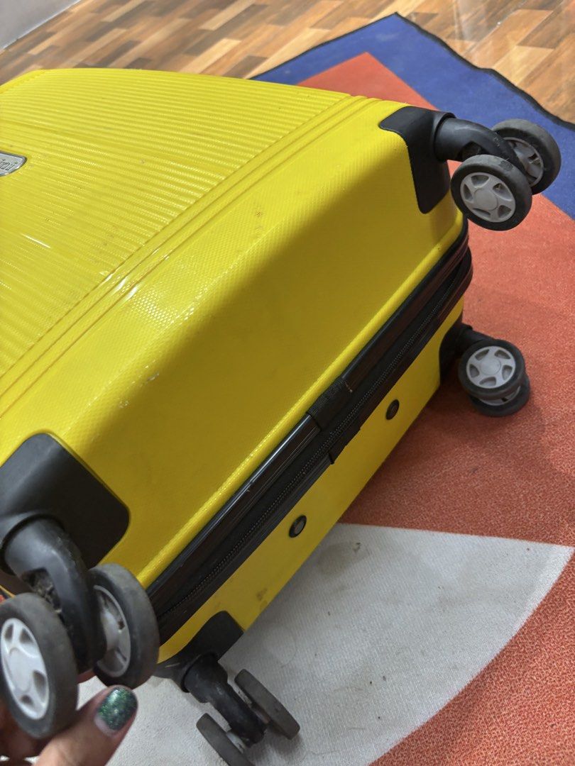 Yellow Hard Shell Spinner Luggage (Category: Luggage) located in Alicia. Submitted by thriftbagph (Listing ID 1462417624, Image 3). Description: - Bright yellow hard shell suitcase - Four spinner wheels for easy gliding - Retractable handle for comfortable transport - Secure zipper closure - Interior features straps and a zippered compartment - Shows minor scuffs and marks from regular travel use - Ideal for your next adventure!.
