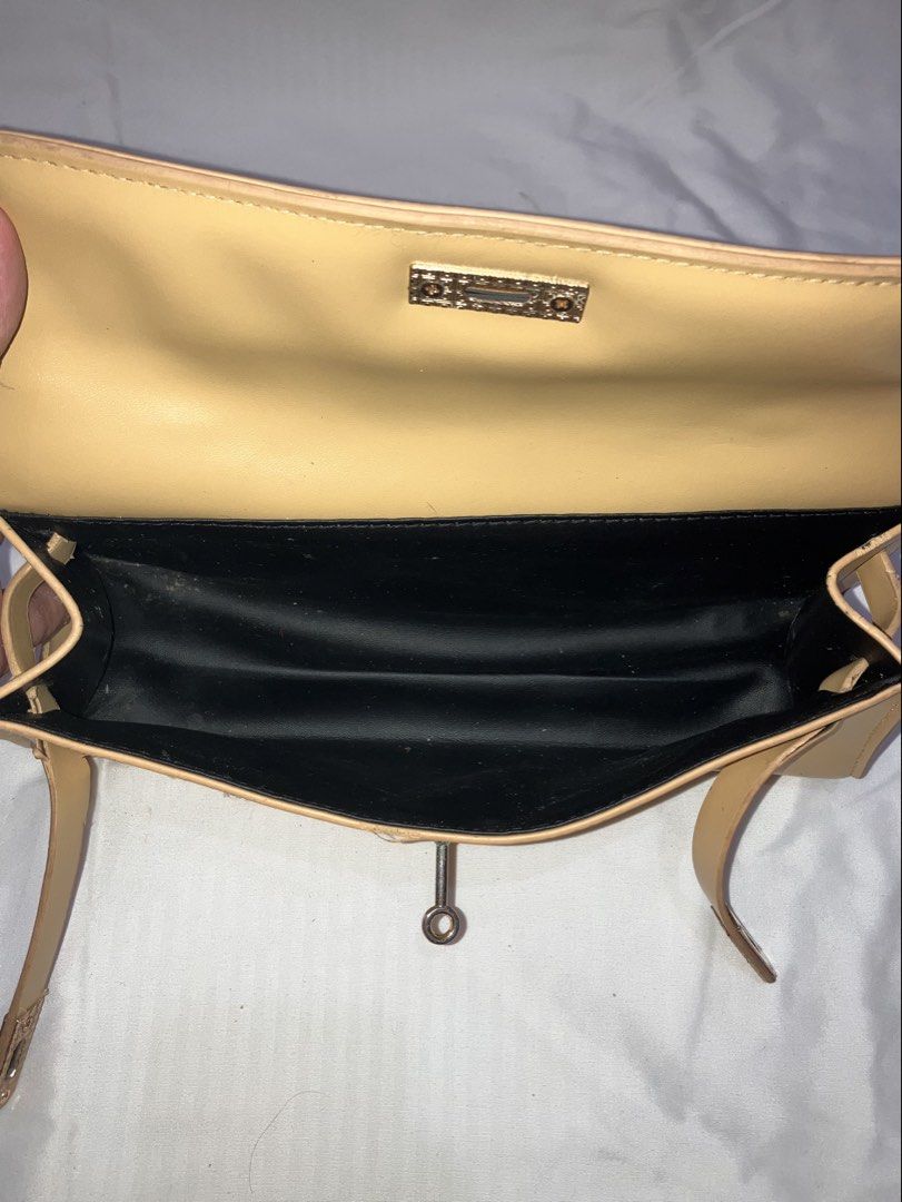 Yellow Shoulder Bag with Gold Clasp (Category: Shoulder Bags) located in Cavite. Submitted by haliadreamz (Listing ID 1462326522, Image 3). Description: - Stylish yellow shoulder bag - Secure gold clasp closure Issues: - Discoloration on hardware - Paint residue on the hardware (the bag was thrifted so idk where the paint came from) - The leather used to close the bag is coming apart on both sides Size: Length- 27.5 cm Height- 13 cm w/o strap, 35