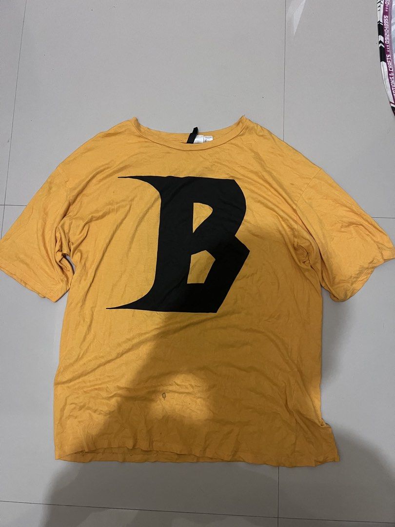 Yellow T-shirt with Black 'B' Graphic (Category: Tshirts & Polo Shirts ) located in Caloocan City. Submitted by vintage2333 (Listing ID 1462413033, Image 1). Description: - Yellow long-sleeve t-shirt - Features a large black 'B' graphic on the front - Comfortable and casual style - Ideal for everyday wear -justin bieber world tour.