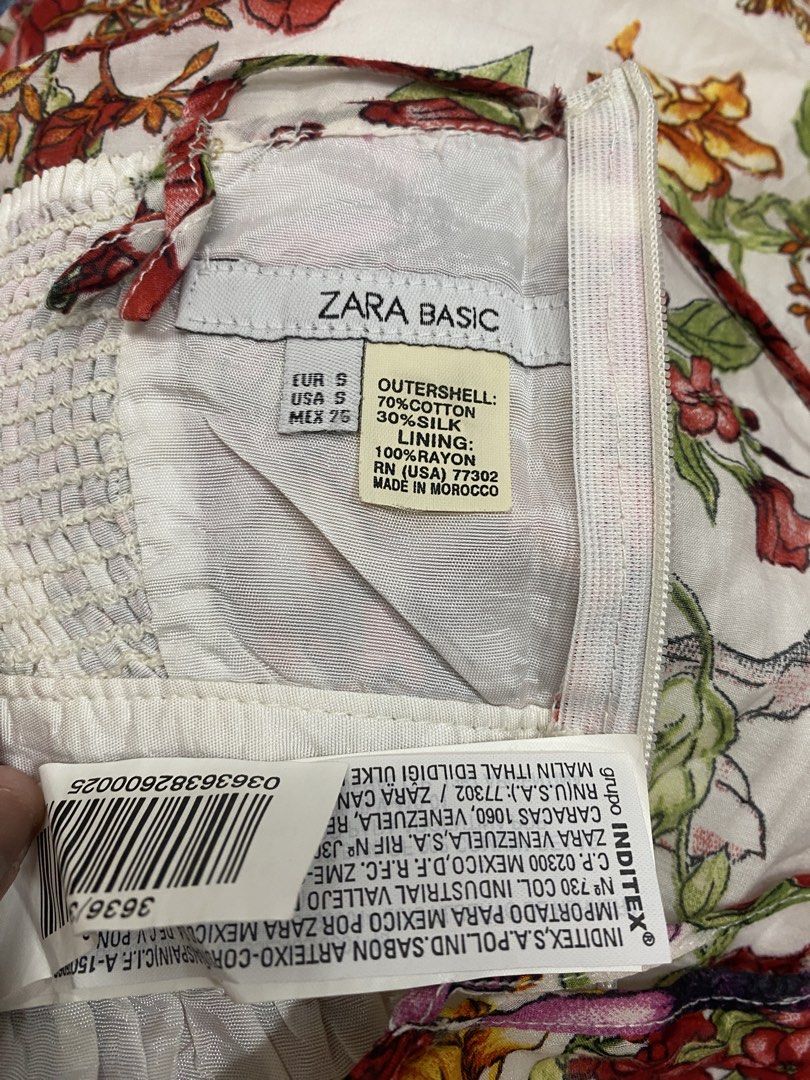 ZARA BASIC Floral Print Midi Dress (Category: Dresses) located in Tanauan. Submitted by oochiecoochie (Listing ID 1462408673, Image 2). Description: White midi dress with a vibrant floral print. Features spaghetti straps and a cinched waist. The fabric is a blend of cotton and silk. Perfect for summer occasions. Made in Morocco. Size S..