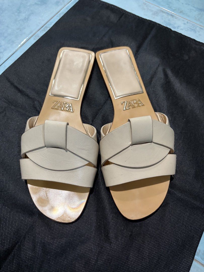 Zara Beige Woven Strap Flat Sandals (Category: Flats & Sandals) located in Mandaluyong City. Submitted by nv0331 (Listing ID 1462435821, Image 1). Description: - Beige Zara flat sandals - Features woven strap detail - Chic square toe design - Convenient slip-on style - Minor scuff marks on sole and straps (as pictured) .