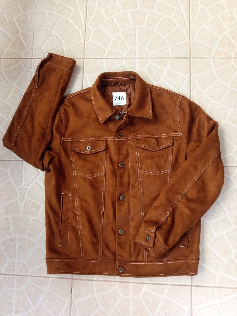 Zara Brown Suede-like Trucker Jacket (Category: Coats, Jackets and Outerwear) located in Liloan. Submitted by dnznoon31 (Listing ID 1462377274, Image 1). Description: - Zara brown trucker jacket - Suede-like material - Quilted lining for extra warmth - Button closure at front and cuffs - Two chest pockets with button closure - Side pockets - Size L - Dimensions 23 x 26 inches - Ideal for layering.
