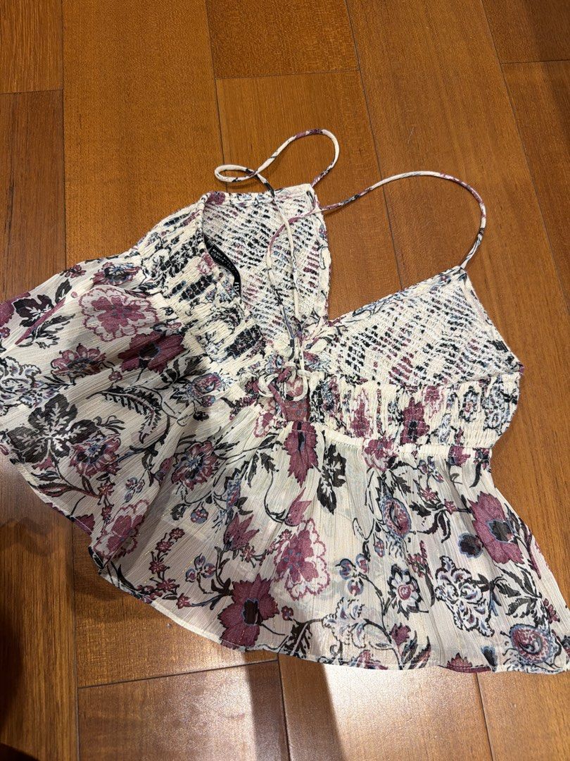 Zara Floral Top XS (Category: Sleeveless) located in Manila. Submitted by megcloset__ (Listing ID 1462359735, Image 2). Description: - Cute floral print crop top from Zara - Smocked bodice for a flattering fit - Adjustable spaghetti straps for comfort - Lightweight and flowy material, perfect for warm weather - Versatile piece: great for casual summer days or nights out.