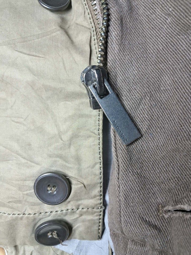 Zara Man Hooded Parka Jacket Medium Olive Green (Category: Coats, Jackets and Outerwear) located in Baguio. Submitted by padisellsz (Listing ID 1462374724, Image 3). Description: - Zara Man Jacket - Color: Olive Green - Size: Medium (M) - Features: Hooded, Button-up front with zipper closure, Two front pockets - Origin: Made in Vietnam - Approximate Measurements: - Pit to Pit: 20.5 inches - Length: 27 inches.