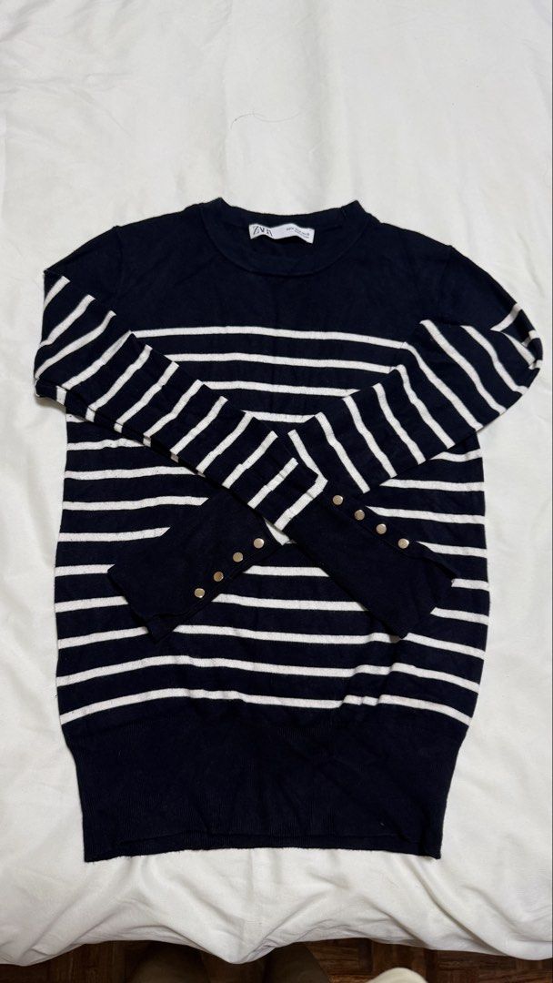 Zara Striped Knit Sweater with gold Button Cuffs (Category: Longsleeves) located in Quezon City. Submitted by beabeys (Listing ID 1462336233, Image 1). Description: - Zara navy and white striped knit sweater - Long sleeves with button cuff details - Classic crew neck design - Comfortable and versatile for layering or solo wear - Easily pairs with jeans or skirts.