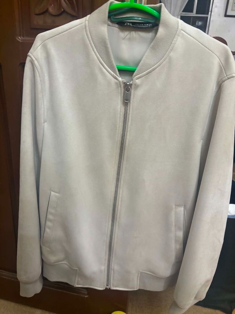 Zara Suede Bomber Jacket (Category: Coats, Jackets and Outerwear) located in Caloocan City. Submitted by capurcosjo05601 (Listing ID 1462396924, Image 2). Description: - Light grey Zara bomber jacket - Suede material - Full zip front - Two side pockets - Ribbed collar, cuffs, and hem - Ideal for layering.