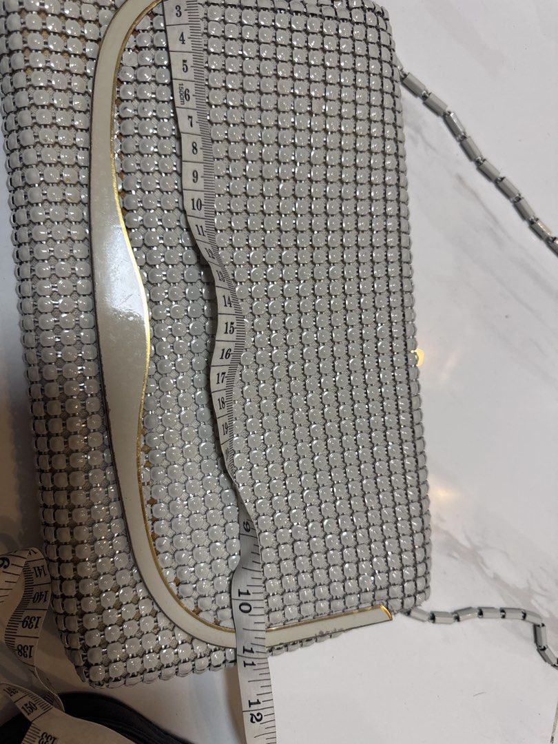 2027 Silver Mesh Clutch Bag with Chain Strap (Category: Clutches) located in Silang. Submitted by sari2bilina (Listing ID 1462601227, Image 2). Description: - Stunning silver mesh clutch bag - Detachable metal chain strap - Luxurious light gold satin interior lining - Secure snap button closure - Dimensions: Approx. 8 inches wide x 5 inches tall - Ideal for evening wear and special occasions.