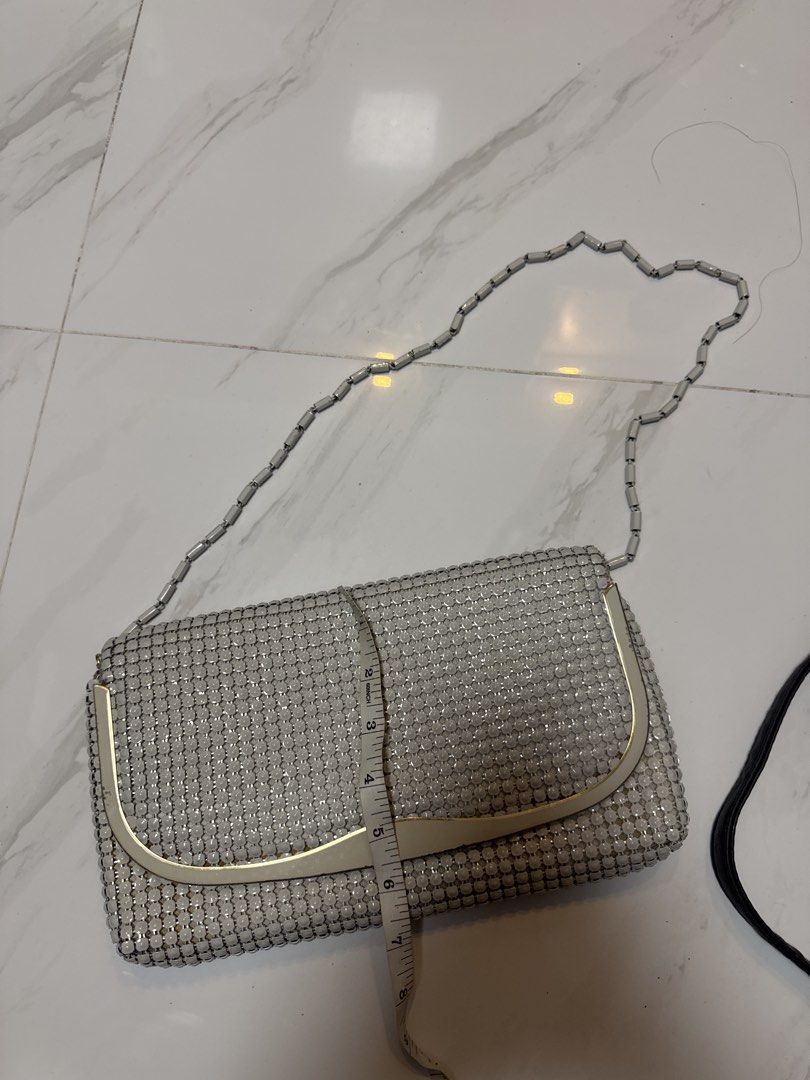 2027 Silver Mesh Clutch Bag with Chain Strap (Category: Clutches) located in Silang. Submitted by sari2bilina (Listing ID 1462601227, Image 1). Description: - Stunning silver mesh clutch bag - Detachable metal chain strap - Luxurious light gold satin interior lining - Secure snap button closure - Dimensions: Approx. 8 inches wide x 5 inches tall - Ideal for evening wear and special occasions.
