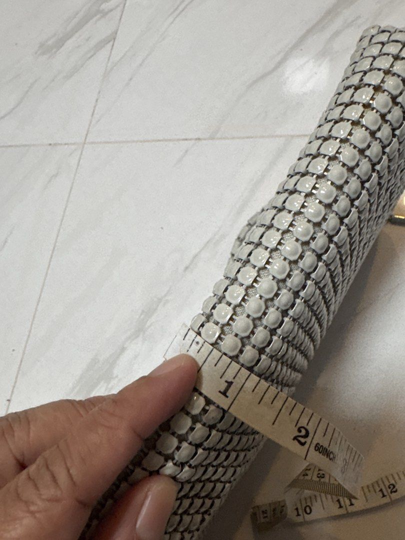 2027 Silver Mesh Clutch Bag with Chain Strap (Category: Clutches) located in Silang. Submitted by sari2bilina (Listing ID 1462601227, Image 3). Description: - Stunning silver mesh clutch bag - Detachable metal chain strap - Luxurious light gold satin interior lining - Secure snap button closure - Dimensions: Approx. 8 inches wide x 5 inches tall - Ideal for evening wear and special occasions.