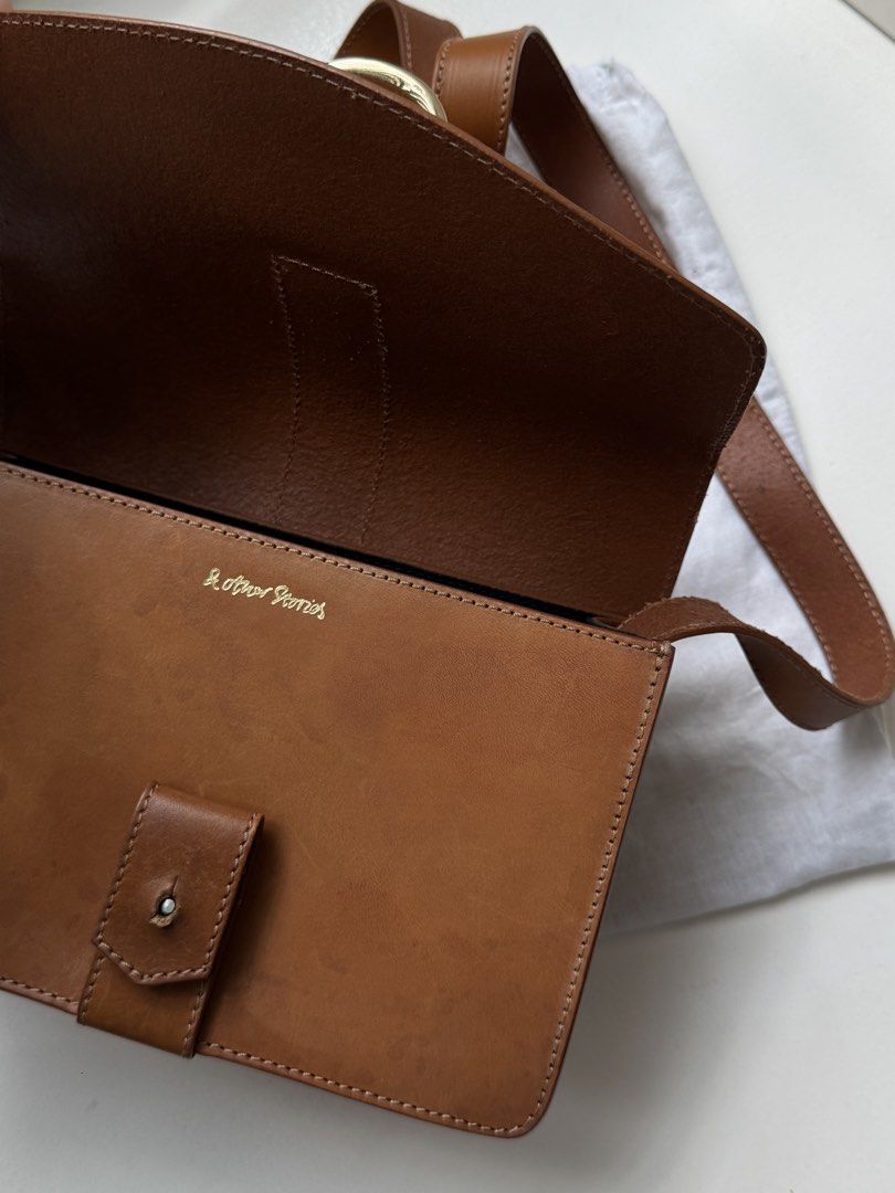 & Other Stories Bag (Category: Shoulder Bags) located in Pasay City. Submitted by shop.stylestaple (Listing ID 1462517569, Image 3). Description: - Brand: & Other Stories - Leather Shoulder Bag with Gold Hardware - Material: Brown Leather - Closure: Gold D-ring buckle - Interior: Black lining - Features: Adjustable strap - Includes: Dust bag - Ideal for: Everyday use.