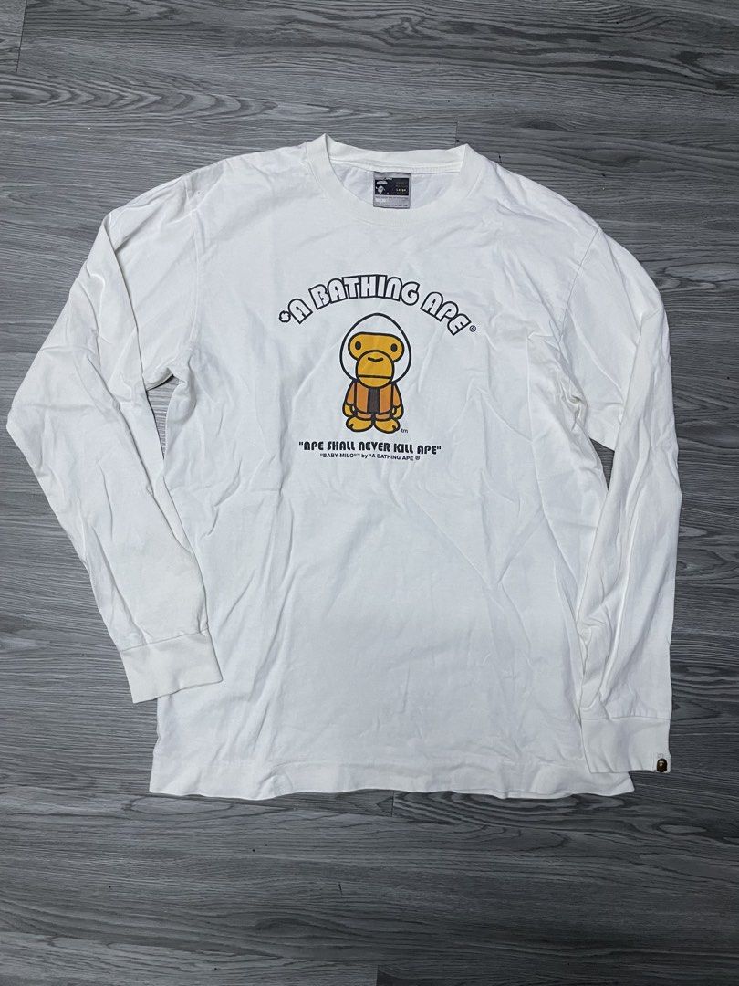 A Bathing Ape Baby Milo Long Sleeve Tee (Category: Tshirts & Polo Shirts ) located in Manila. Submitted by yourfavoriteplug (Listing ID 1462508520, Image 1). Description: - Brand: A Bathing Ape (BAPE) - Color: White - Style: Long Sleeve T-Shirt - Graphic: Iconic Baby Milo - Text Detail: 'Ape Shall Never Kill Ape' - Size: Large (L) - Condition: Great (for BAPE fans).