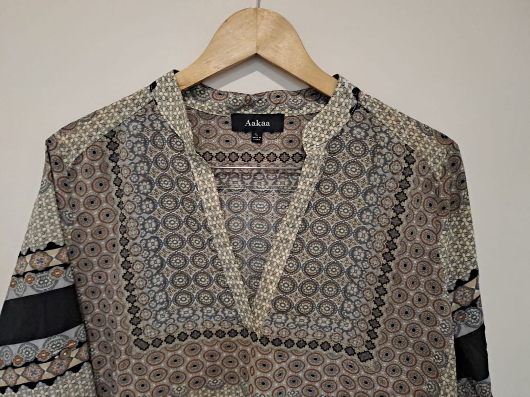 Aakaa tunic cover up beach tops (Category: Others Tops) located in Mandaluyong City. Submitted by epicowl-c93c (Listing ID 1462587053, Image 2). Description: This item is an Aakaa geometric print longline tunic, featuring a semi-sheer fabric design with 3/4 sleeves, a band collar, and a split V-neckline..