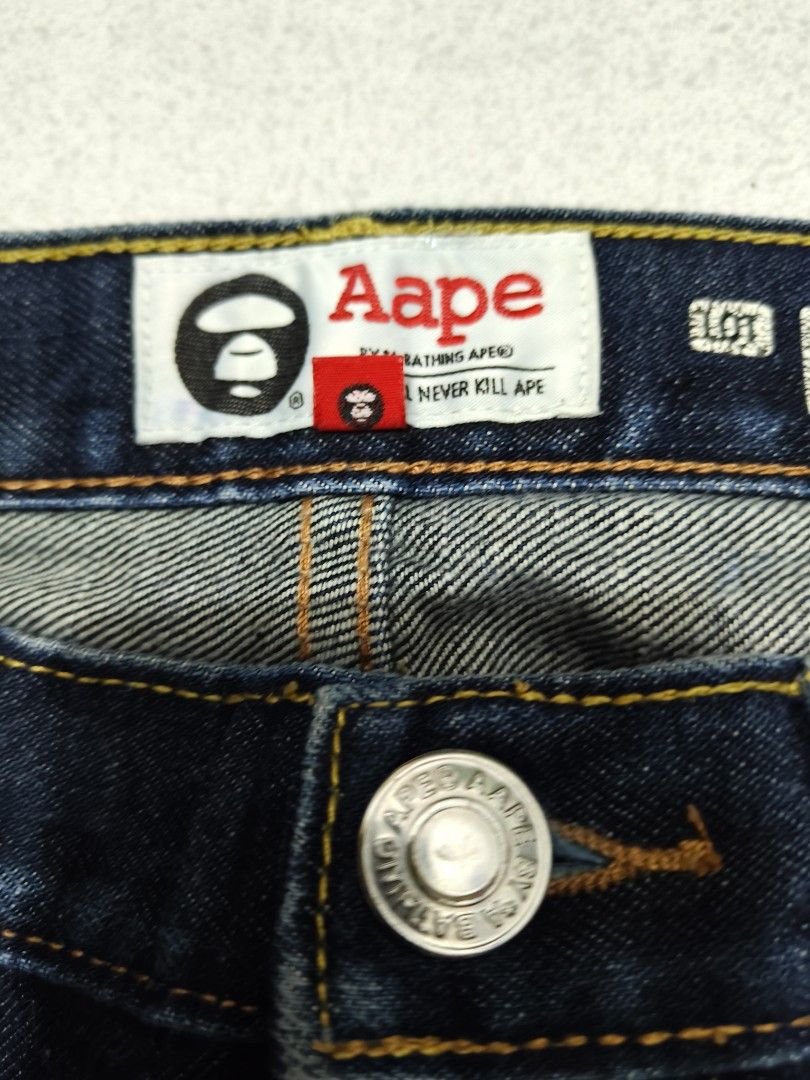 AAPE BY A BATHING APE Union Jeans (Category: Jeans) located in Manila. Submitted by truehorse-68cf (Listing ID 1462445515, Image 3). Description: - Brand: AAPE BY A BATHING APE - Style: Dark wash denim jeans - Feature: 'Aape Now Union' graphic print on right leg - Fit: Regular fit - Closure: Button and zip - Pockets: Classic five-pocket styling - Occasion: Great for casual wear w-34/31 L-41 authentic excellent condition accepting offers.