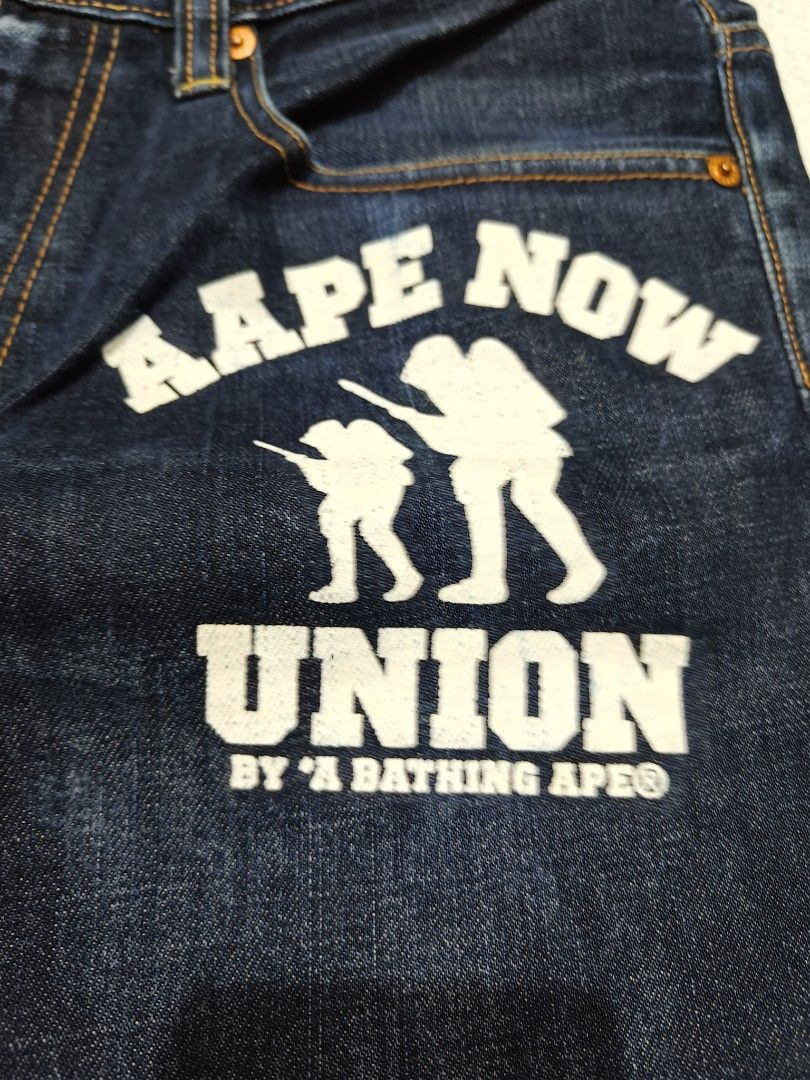 AAPE BY A BATHING APE Union Jeans (Category: Jeans) located in Manila. Submitted by truehorse-68cf (Listing ID 1462445515, Image 2). Description: - Brand: AAPE BY A BATHING APE - Style: Dark wash denim jeans - Feature: 'Aape Now Union' graphic print on right leg - Fit: Regular fit - Closure: Button and zip - Pockets: Classic five-pocket styling - Occasion: Great for casual wear w-34/31 L-41 authentic excellent condition accepting offers.