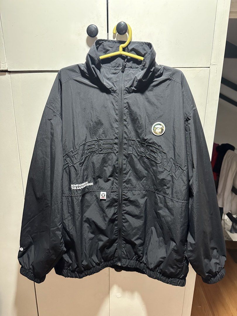 AAPE NOW Black Windbreaker Jacket (Medium) (Category: Coats, Jackets and Outerwear) located in Manila. Submitted by gentletiger_7ad919 (Listing ID 1462566689, Image 1). Description: - Black AAPE NOW windbreaker jacket - Features graphic print on front and back - Elasticated cuffs and hem - Lightweight material, ideal for layering - Great for casual wear.