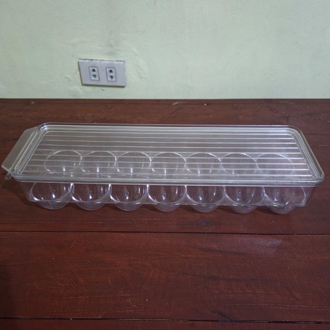 Acrylic 14-Grid Covered Egg Holder Tray with Lid (Category: Food Organization & Storage) located in Quezon City. Submitted by bravewaters (Listing ID 1462595357, Image 1). Description: - Clear acrylic/plastic egg storage tray with a removable lid. - Keeps eggs fresh, organized, and stackable in the refrigerator or pantry. - Clean and simple space-saving design for kitchen storage. - ​Holds up to 14 eggs - ​Clear plastic container with textured li