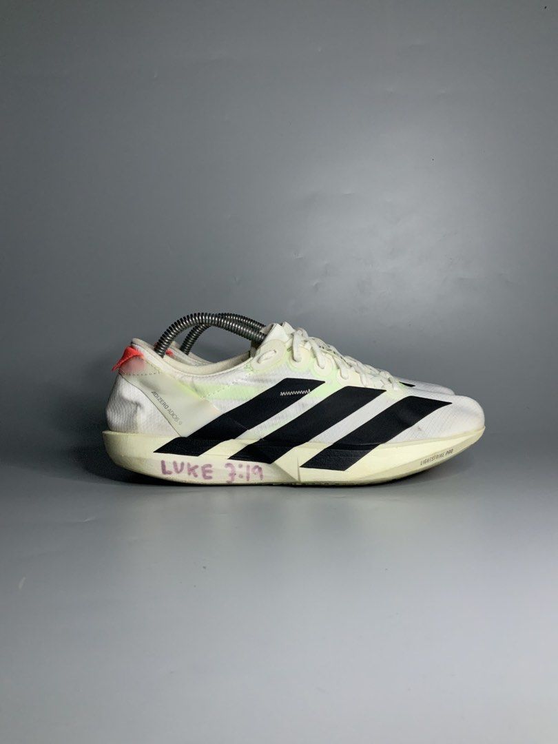 Adidas Adizero Adios 9 (Category: Sneakers) located in Cavite. Submitted by kalye_footwear (Listing ID 1462653163, Image 2). Description: - Adidas Adizero Adios 9 - Us 8 , Euro 41.5 , Cm 26 - Color: White with black stripes - Cushioning: Lightstrike Pro - Ideal for: Racing and fast training - Condition: Some writing on the sides (please check photos for details) .
