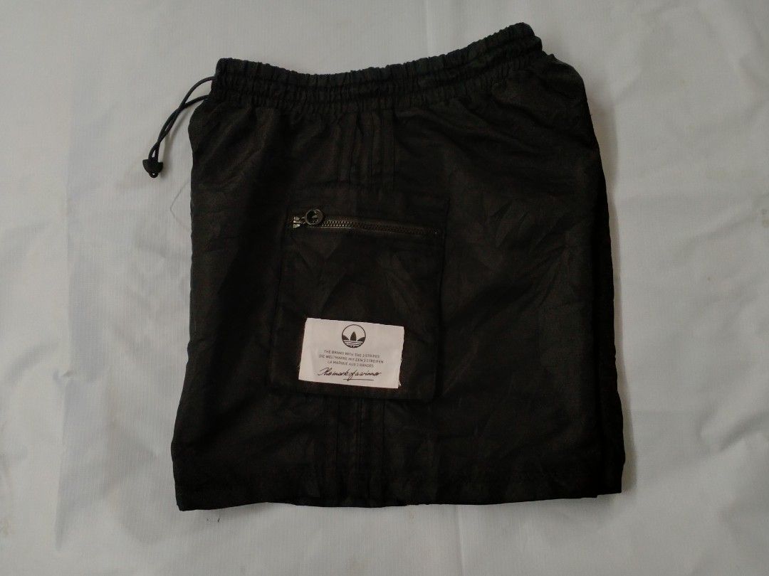 Adidas Black Cargo Shorts with Zippers (Category: Shorts) located in Davao. Submitted by ervinpolino09 (Listing ID 1462440459, Image 2). Description: - Black Adidas cargo shorts - Elastic waistband with drawstring - Two zippered front pockets - Two flap pockets - Adidas logo patch on right side - Made in Cambodia - Ideal for casual wear or sports Size 25-30 Length 14.5 Like New Condition Location Davao City .