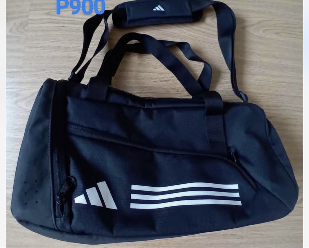Adidas Black Duffel Bag with White Stripes (Category: Backpacks) located in Pasig City. Submitted by pooja1808.gupta (Listing ID 1462509376, Image 1). Description: - Classic black Adidas duffel bag - Features iconic white three stripes on the side - Comes with a detachable shoulder strap and comfortable handles - Stylish perforated details on the side - Perfect for gym sessions or weekend getaways.