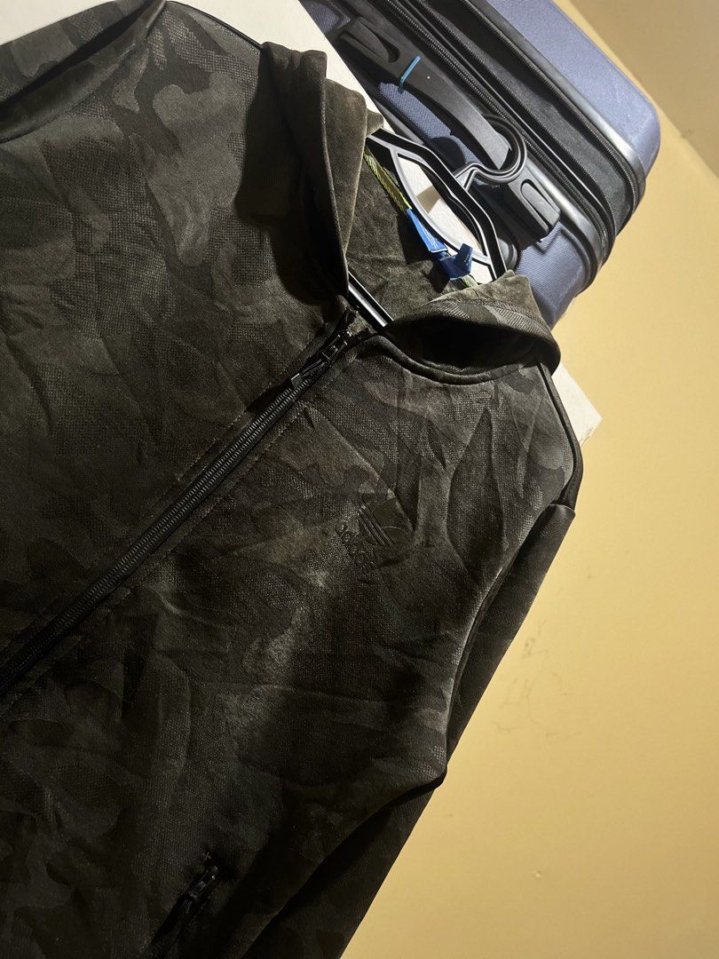 Adidas Camo Zip-Up Hoodie (Category: Coats, Jackets and Outerwear) located in Manila. Submitted by jezrathrift (Listing ID 1462673564, Image 2). Description: - Cool Adidas camo print hoodie - Full zip-up front with hood - Two secure zip pockets - Ribbed cuffs and hem for a snug fit - Ideal for everyday casual wear.