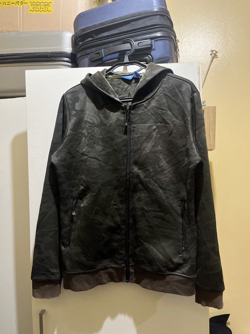 Adidas Camo Zip-Up Hoodie (Category: Coats, Jackets and Outerwear) located in Manila. Submitted by jezrathrift (Listing ID 1462673564, Image 1). Description: - Cool Adidas camo print hoodie - Full zip-up front with hood - Two secure zip pockets - Ribbed cuffs and hem for a snug fit - Ideal for everyday casual wear.