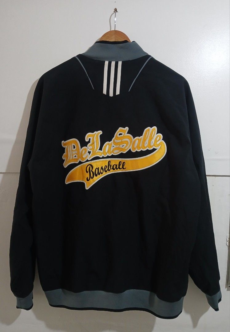 Adidas De La Salle Baseball Track Jacket Size M (Category: Coats, Jackets and Outerwear) located in Taguig. Submitted by thriftnilhan (Listing ID 1462490776, Image 2). Description: - Black Adidas track jacket - Size: Medium (W 23 L 29) - 'De La Salle Baseball' embroidered on back - Number '11' on front - Grey accents on collar, cuffs, and hem - Made in Indonesia.