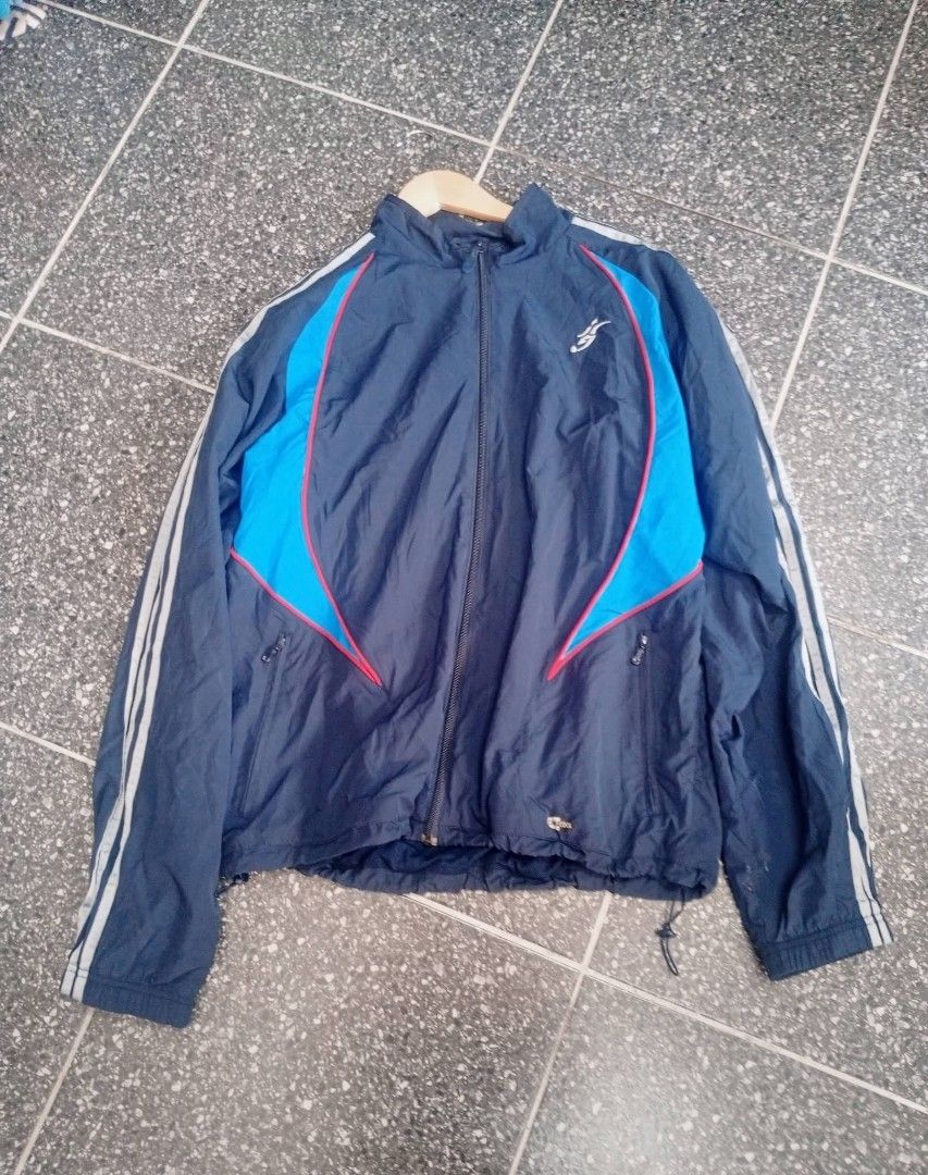 Adidas Navy Blue Track Jacket (Category: Coats, Jackets and Outerwear) located in Manila. Submitted by annemanzano120906 (Listing ID 1462553096, Image 1). Description: - Navy blue Adidas track jacket - Size L - Light blue and red accents on the front - Three white stripes on the sleeves - Features pockets - Drawstring at the hem.
