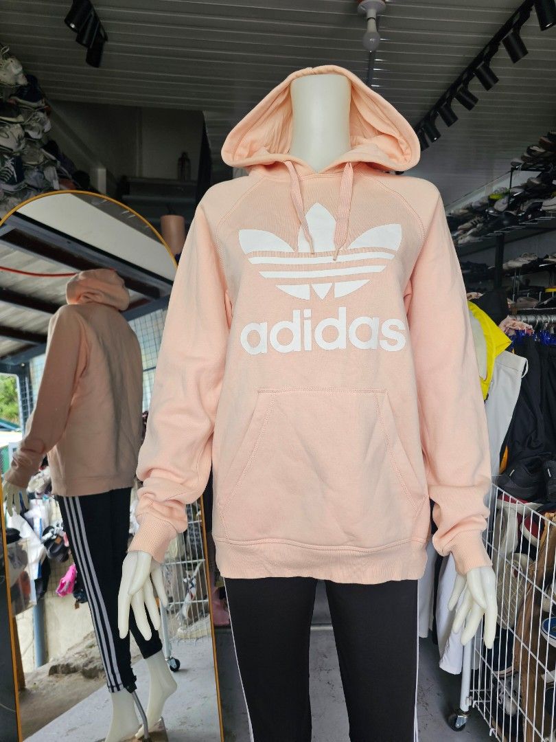 Adidas Peach Hoodie Sweatshirt (Category: Coats, Jackets and Outerwear) located in Baguio. Submitted by kayeonlineshop (Listing ID 1462514929, Image 1). Description: -peach-colored Adidas Originals hoodie featuring the iconic white Trefoil logo and wordmark across the chest. -measurements included in the photos.