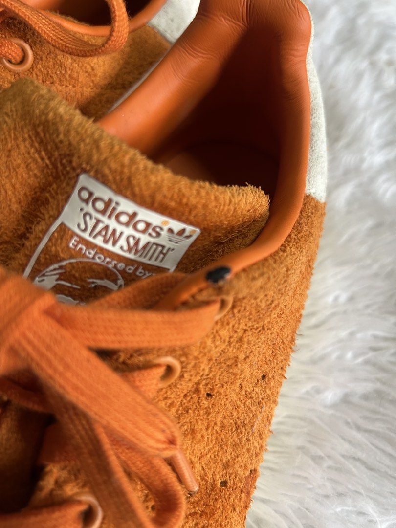 Adidas Stan Smith Suede Orange Sneakers (Category: Sneakers) located in Cavite. Submitted by mamamia73 (Listing ID 1462649257, Image 2). Description: - Orange suede Adidas Stan Smith sneakers - Classic design with iconic branding - Soles show some wear but have good grip - Matching orange laces - Perfect for casual wear.