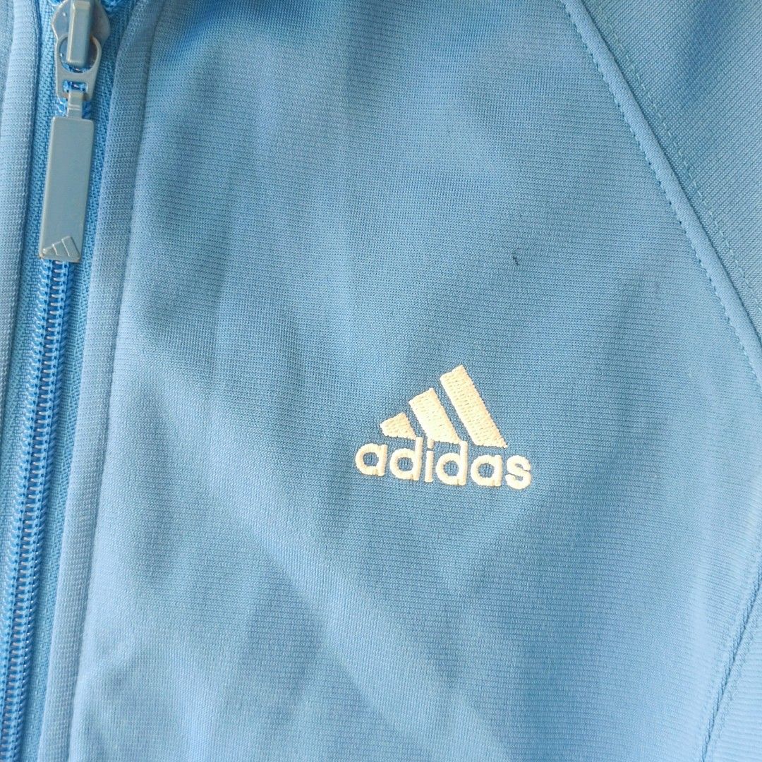 Adidas Track Jacket Blue White Black Stripes (Category: Coats, Jackets and Outerwear) located in Pasig City. Submitted by prelovedbym33 (Listing ID 1462459325, Image 3). Description: - Classic blue Adidas track jacket - Signature three stripes on sleeves - Full zip closure - Ribbed cuffs and hem for a snug fit - Two convenient side pockets - Ideal for everyday wear or athletic activities.