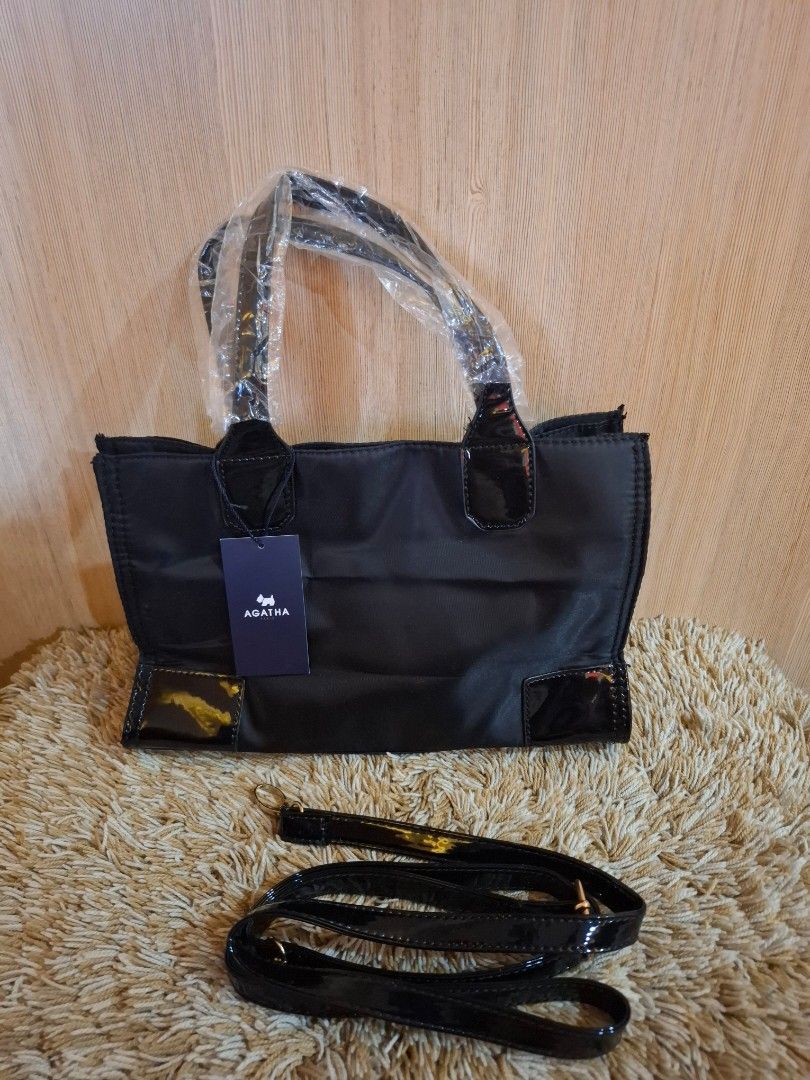 AGATHA PARIS Black Tote Bag with Shoulder Strap (Category: Tote Bags) located in Rizal. Submitted by mirisica (Listing ID 1462564627, Image 2). Description: - Brand: AGATHA PARIS - Color: Black - Style: Tote Bag - Features: Top handles, detachable shoulder strap, patent exterior details - Interior: Zippered pocket, slip pocket - Condition: New with original tag - Ideal for: Everyday use.