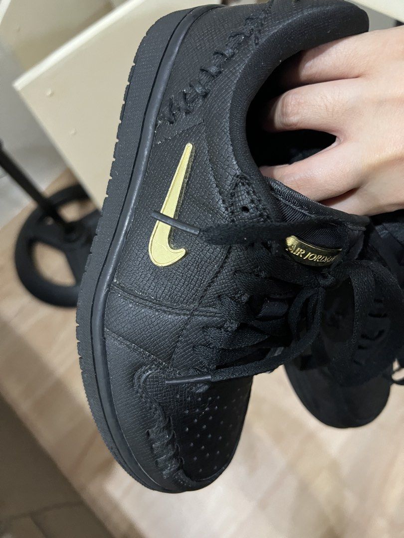 Air Jordan 1 Low Black Gold (Category: Sneakers) located in Muntinlupa City. Submitted by lememoir (Listing ID 1462614651, Image 3). Description: - Size 6 and 7 Womens (can fit) - Classic Black Air Jordan 1 Low silhouette - Eye-catching gold accents on Nike swoosh and heel logo - Unique textured upper for added style - Comes with sleek black laces - Features a fun pink glitter Air Jordan logo on the insoles - Perfect addition to any sneakerhead's
