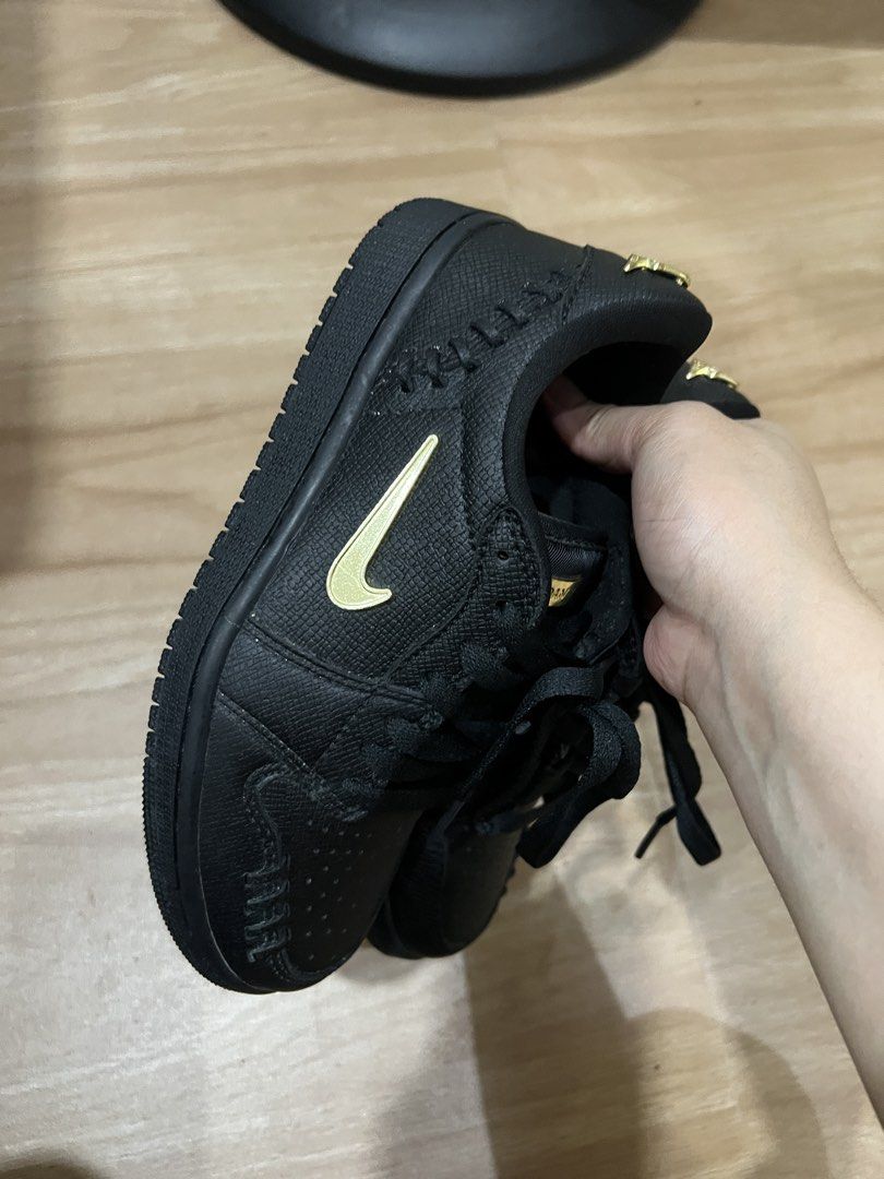 Air Jordan 1 Low Black Gold (Category: Sneakers) located in Muntinlupa City. Submitted by lememoir (Listing ID 1462614651, Image 1). Description: - Size 6 and 7 Womens (can fit) - Classic Black Air Jordan 1 Low silhouette - Eye-catching gold accents on Nike swoosh and heel logo - Unique textured upper for added style - Comes with sleek black laces - Features a fun pink glitter Air Jordan logo on the insoles - Perfect addition to any sneakerhead's