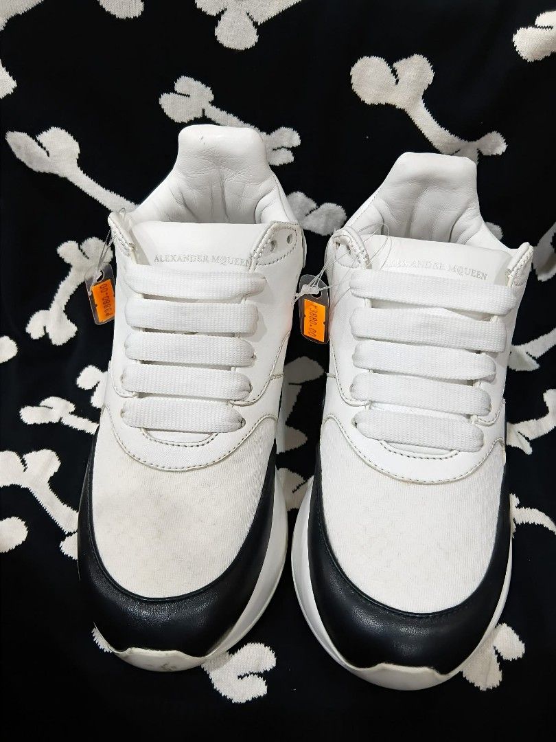 Alexander McQueen Oversized Sneakers White Black Leather (Category: Sneakers & Footwear) located in Subic. Submitted by adamdwyane (Listing ID 1462477379, Image 2). Description: - Authentic Alexander McQueen oversized sneakers - White leather with black toe and heel accents - Iconic chunky white sole - White laces - Interior is clean - Perfect for making a bold fashion statement.