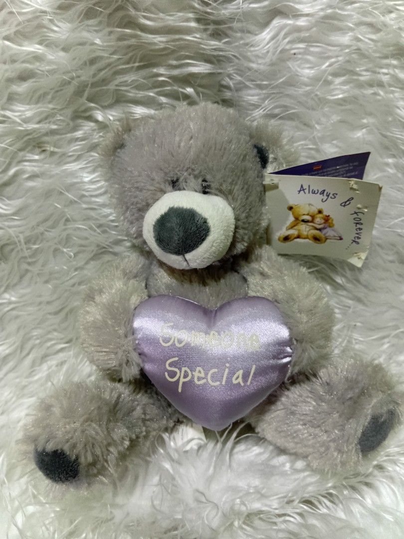 Always and forever gray plush teddy bear (Category: Plushies & Soft Toys) located in Caloocan City. Submitted by aims90 (Listing ID 1462623582, Image 1). Description: Product Details Material: Soft gray faux fur with dark grey paw pads and a white muzzle. Accessory: A satin purple heart embroidered with "Someone Special" in silver text. Tag: Includes an "Always & Forever..." gift tag.