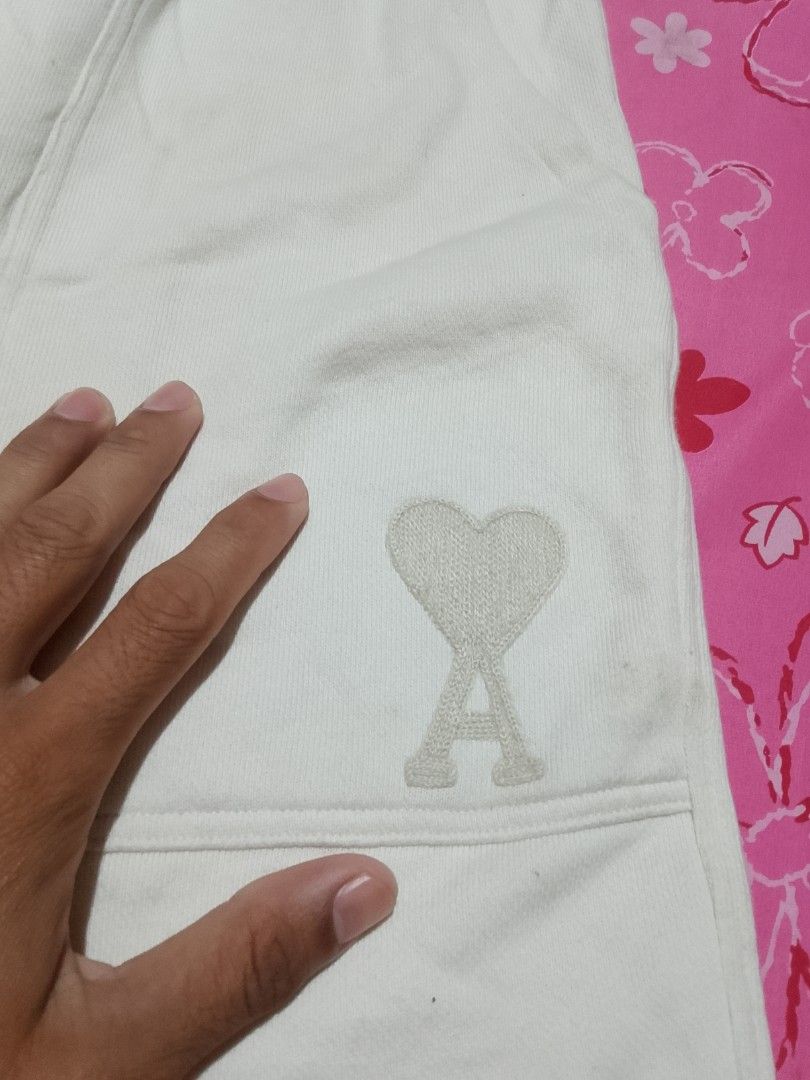 AMI Paris White Shorts with Heart Logo (Category: Shorts) located in Iloilo. Submitted by janillthrifted (Listing ID 1462615217, Image 2). Description: - White AMI Paris shorts - Signature Ami de Coeur logo embroidered on the side - Elastic waistband with adjustable drawstring - Two convenient front pockets - Comfortable and stylish for everyday wear.