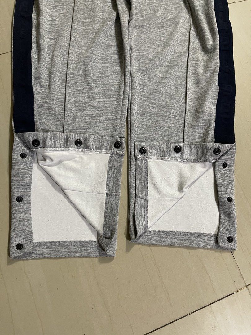 AND1 Grey Snap Button Track Pants (Category: Joggers) located in Manila. Submitted by stuzzygod (Listing ID 1462625645, Image 3). Description: - Brand: AND1 - Color: Grey - Features: Snap buttons down the sides of the legs - Waistband: Elastic with drawstring - Origin: Made in Cambodia - Size: 36-38 - Length 39 - Leg open 8 - Ideal for: Sports or casual wear.
