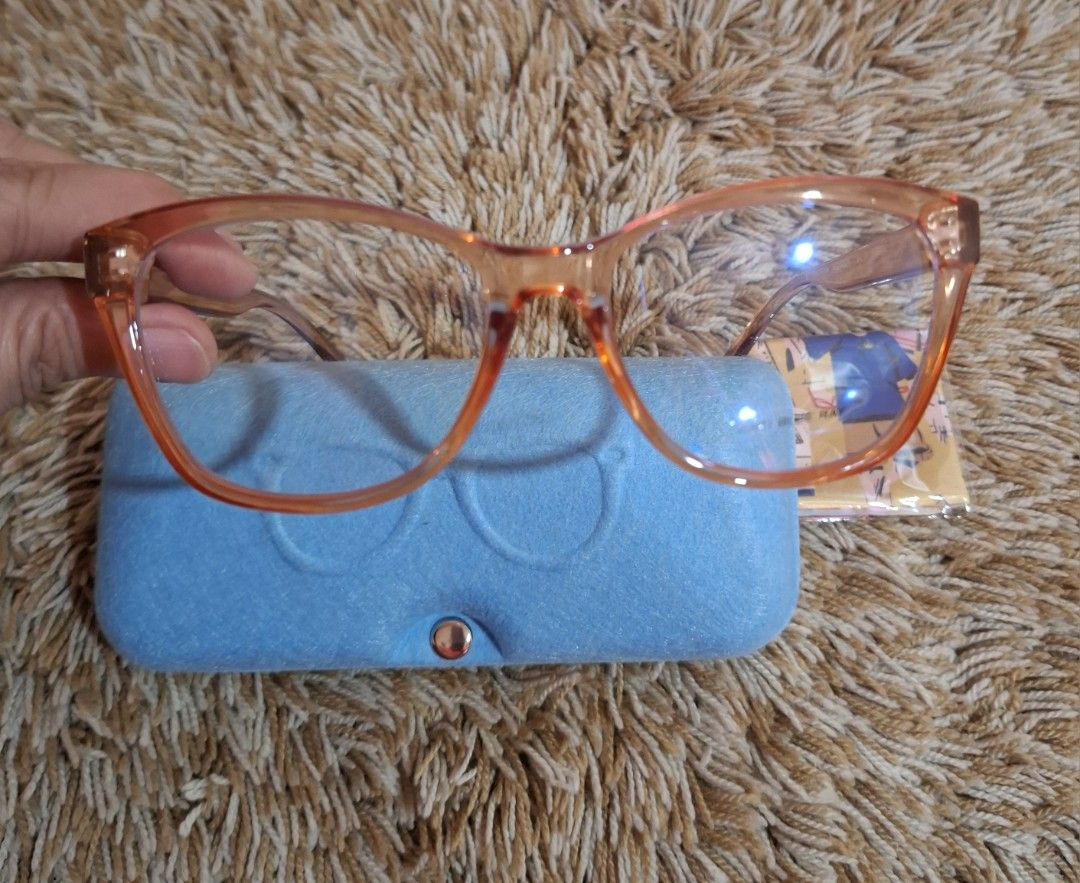 Antepara BT21 Eyeglasses (Category: Sunglasses & Eyewear) located in Rizal. Submitted by mirisica (Listing ID 1462568573, Image 3). Description: - Trendy orange cat-eye frames - Anti-blue light lenses for eye protection - Comes with a protective blue hard case - Includes a microfiber cleaning cloth - Adorable character designs on the arms - Ideal for daily computer use and gaming - Protect your eyes while looking stylish.