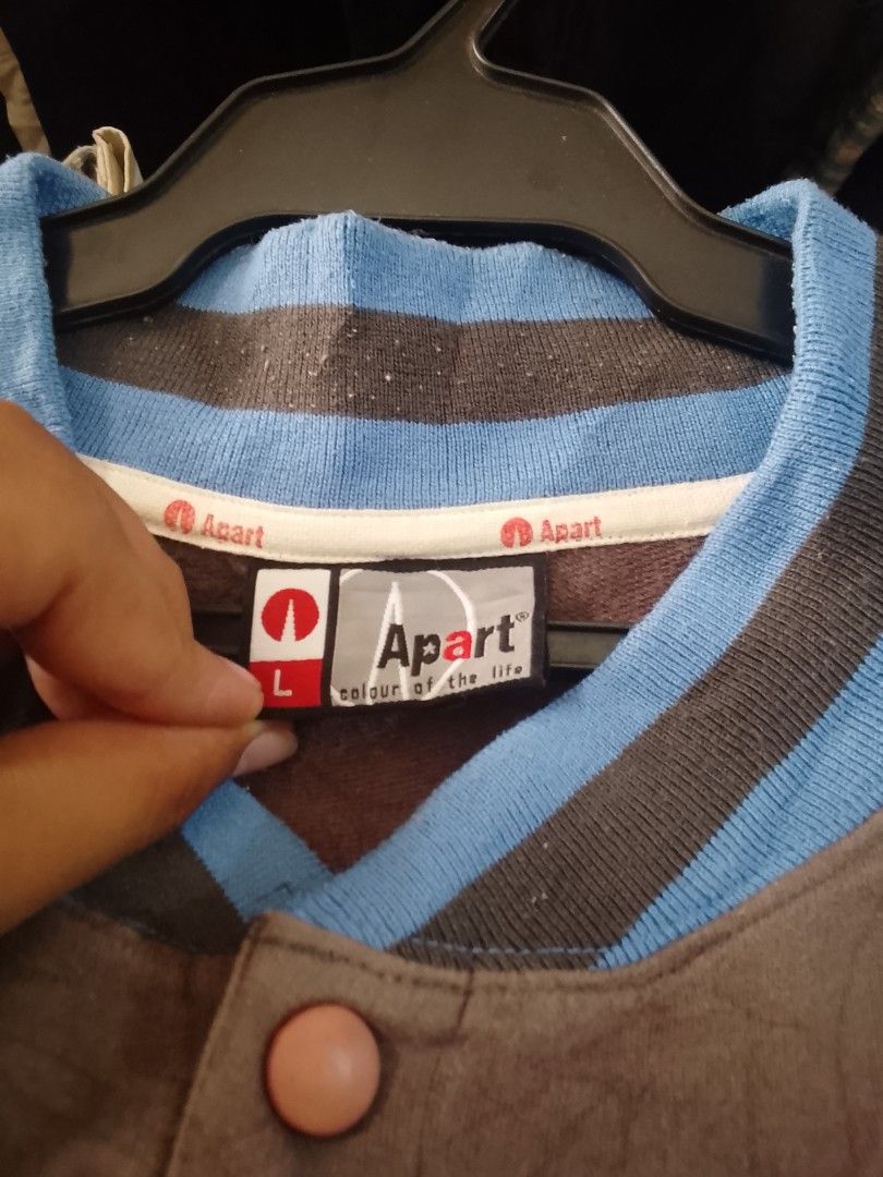 Apart Varsity Jacket Size L (Category: Coats, Jackets and Outerwear) located in Manila. Submitted by warmcloud-06f3 (Listing ID 1462555629, Image 2). Description: - Brand: Apart - Style: Brown Varsity Jacket - Size: L - Details: Blue and grey striped collar and cuffs - Chest: 'ASA' embroidery - Back: Graffiti-style design - Closure: Button-up front.