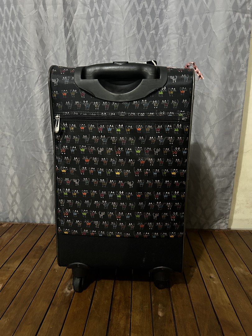 ATSUKI ONISHI (Category: Luggage) located in Taguig. Submitted by ghiebow06 (Listing ID 1462614071, Image 3). Description: with lock and key Dimensions: H- 22 1/2 W- 13 D- 8 Issue: scratches - Black rolling suitcase with a fun cartoon cat pattern. - Retractable handle and wheels for easy mobility. - Front zipper pocket for quick access to essentials. - Versatile for travel or everyday use..