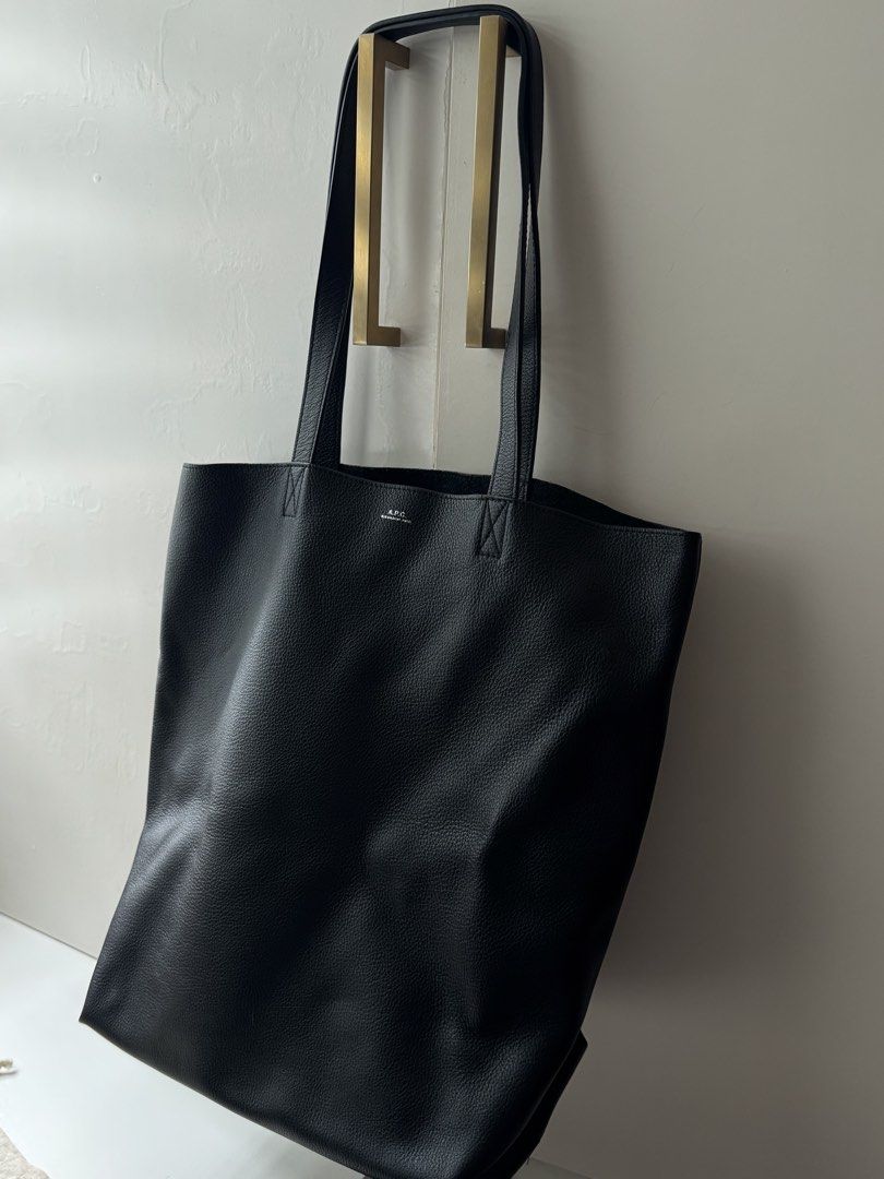 Auth APC Tote Bag (Category: Tote Bags) located in Pasay City. Submitted by shop.stylestaple (Listing ID 1462516077, Image 3). Description: - Classic black leather tote - Brand: A.P.C. - Simple and spacious design - Great for everyday use - Nice leather texture - Comes with original dust bag - Versatile and fits a lot Bought for 26,000 Used once only Selling for 18500.