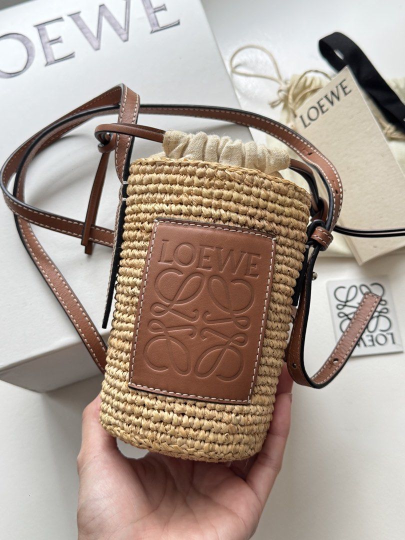Auth Loewe Raffia Basket Bag (Category: Luxury Bags & Wallets) located in Pasay City. Submitted by shop.stylestaple (Listing ID 1462509082, Image 2). Description: - Authentic Loewe basket bag - Made from raffia and calfskin - Comes with original dust bag and tags - Purchased from Mr Porter - Ideal for summer outings Selling super low at 36,000php.