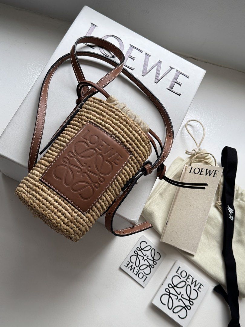 Auth Loewe Raffia Basket Bag (Category: Luxury Bags & Wallets) located in Pasay City. Submitted by shop.stylestaple (Listing ID 1462509082, Image 1). Description: - Authentic Loewe basket bag - Made from raffia and calfskin - Comes with original dust bag and tags - Purchased from Mr Porter - Ideal for summer outings Selling super low at 36,000php.