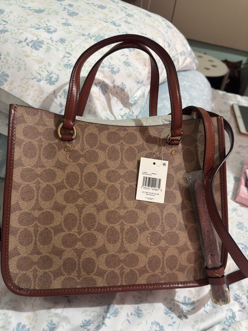 AUTHENTIC Coach Signature Tote Bag - B4/TAN RUST (Category: Luxury Bags & Wallets) located in Cainta. Submitted by trufflecake (Listing ID 1462467939, Image 2). Description: - Authentic Coach tote bag - Signature print in tan rust color - Genuine leather trim and handles - Interior zip pocket for essentials - Detachable strap for versatile carrying - Made in Indonesia - Brand new with tag still attached.