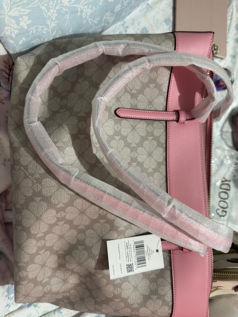 Authentic Kate Spade Tote Bag with Heart Charm (Category: Tote Bags) located in Cainta. Submitted by trufflecake (Listing ID 1462537975, Image 2). Description: - Authentic BRAND NEW Kate Spade tote bag - Features signature spade flower pattern - Adorable pink heart charm included - Stylish pink trim and handles - Comes with a detachable shoulder strap - Brand new with original tags attached.