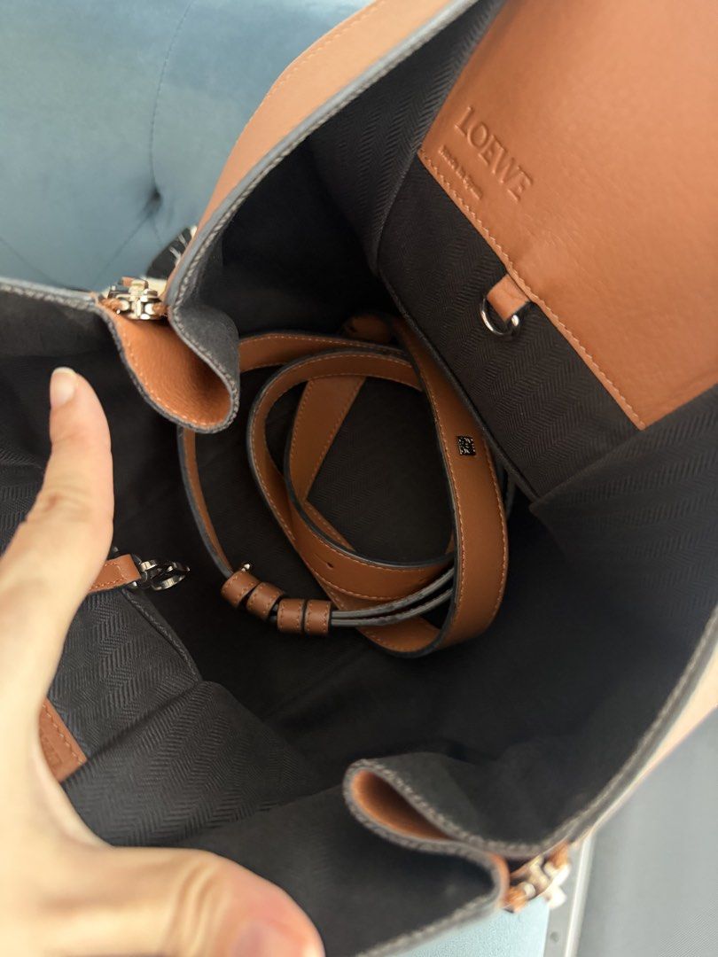 Authentic Loewe Hammock Bag Tan Leather (Category: Luxury Bags & Wallets) located in Taguig. Submitted by claire08hyun (Listing ID 1462559371, Image 3). Description: - Authentic Loewe Hammock bag - Medium size - Color: Tan leather - Closure: Zipper - Interior: Zipped pocket and strap - Condition: Some wear on handles & straps - Includes: Original dust bag - Ideal for: Everyday use.