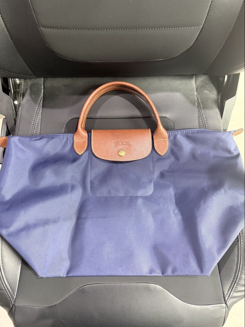 AUTHENTIC LONGCHAMP BAG (Category: Shoulder Bags) located in Paranaque City. Submitted by lulusthreadsandthings (Listing ID 1462652062, Image 2). Description: Authentic Long Champ Bag - Medium size - Short handle - Navy blue color - Brown handle - Mint condition - Price at 4,500 (negotiable) - Shipping fee shoulder by buyer See actual photos .